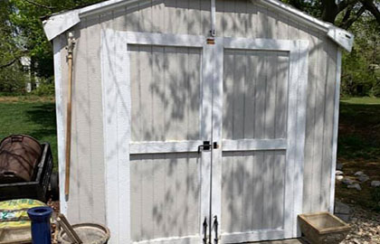 Photo of a white and gray shed