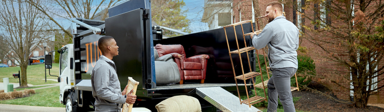 JunkCo workers moving furniture into a truck