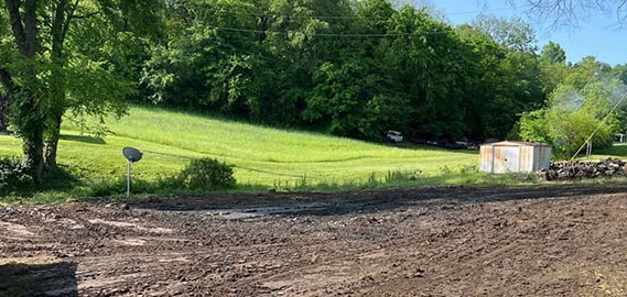 An empty lot of dirt after residential demolition