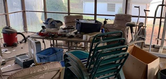 Screen porch with old junk furniture